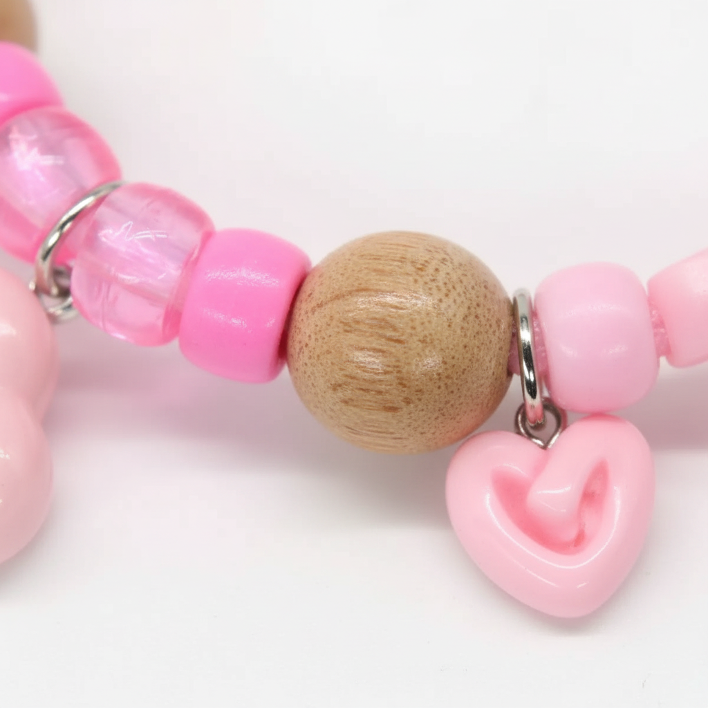 Close-up of natural camphor wood beads on pink pet collar